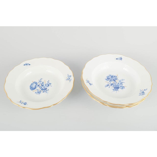 Meissen 4 deep plates, early 20th century. Hand-decorated porcelain with hand-painted blue floral decoration and gilded...