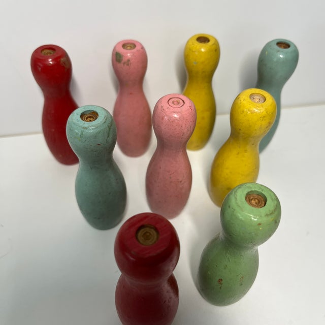 Charming vintage set of nine pastel colored tabletop bowling pins. Nine in all. Wood. Pink, pale green, yellow, pale blue...
