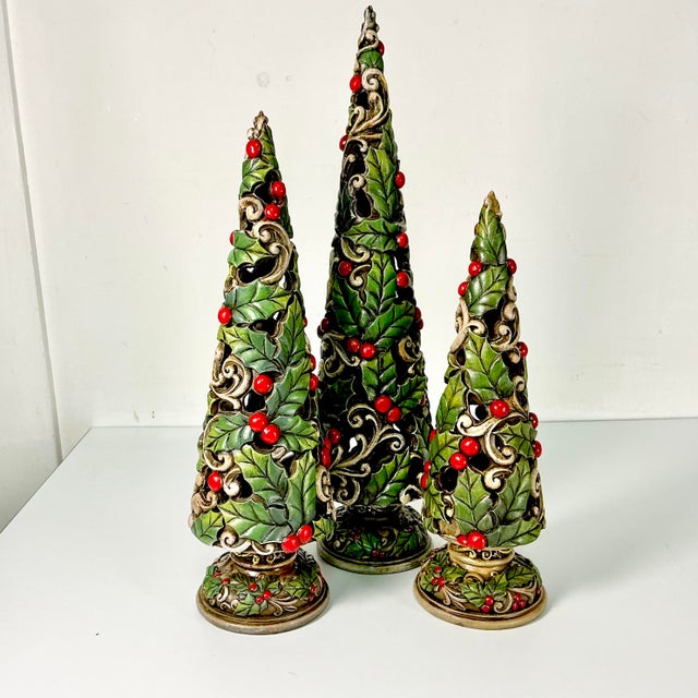 These are lovely. A set of three tree-like Holly Topiaries in three sizes. They are gorgeous when displayed in a cluster...