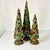 These are lovely. A set of three tree-like Holly Topiaries in three sizes. They are gorgeous when displayed in a cluster...