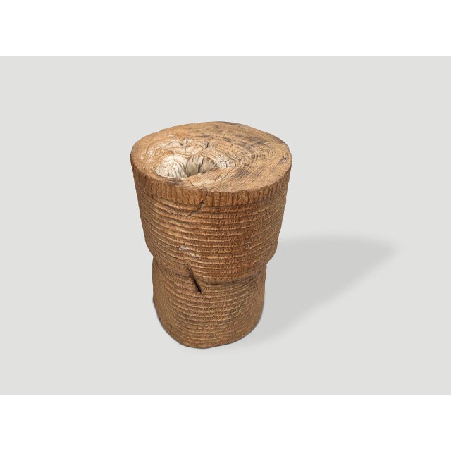 A beautiful ancient mortar originally used to pound rice from Sumatra, is repurposed as an art piece, container or side...