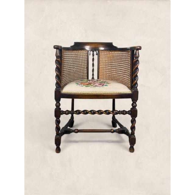A beautiful antique English Edwardian tub chair dating to circa 1910, crafted from solid oak and showcasing elegant barley...