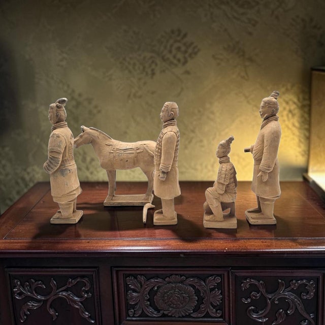 This boxed five-piece Terracotta Warriors replica set was produced in China during the late twentieth century as an...