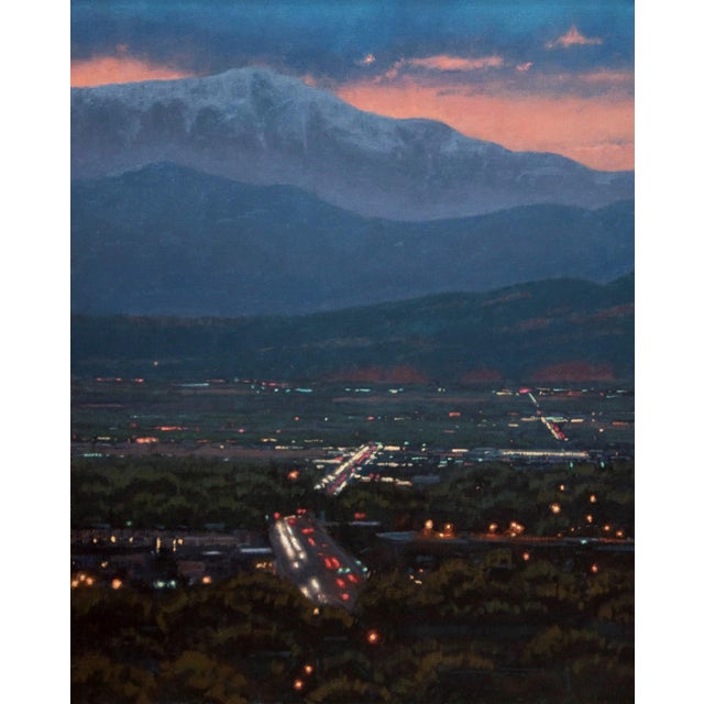 This oil painting captures a serene twilight view of Colorado Springs, where soft hues of dusk blend seamlessly into the...