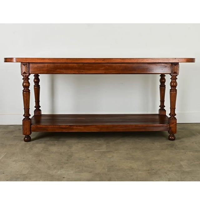 Dimensions: 34 ⅛” H x 78 ¾” W x 30 ½” D A unique drapery table from the region of Burgundy, France, dating to the late...