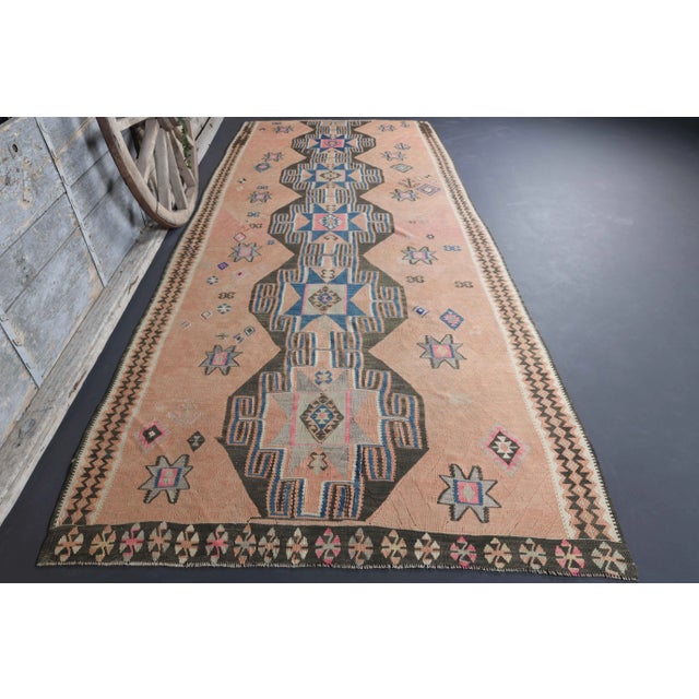 Vintage Turkish Hand-Knotted vintage rug is a semi-Vintage kilim runner rug.'70s Eastern region of Turkey's unique rug is...