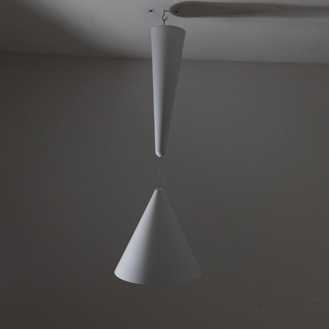 Diablo pendant lamp, designed by Achille Castiglioni for Flos in 1970. The metal frame features a blue and white finish...