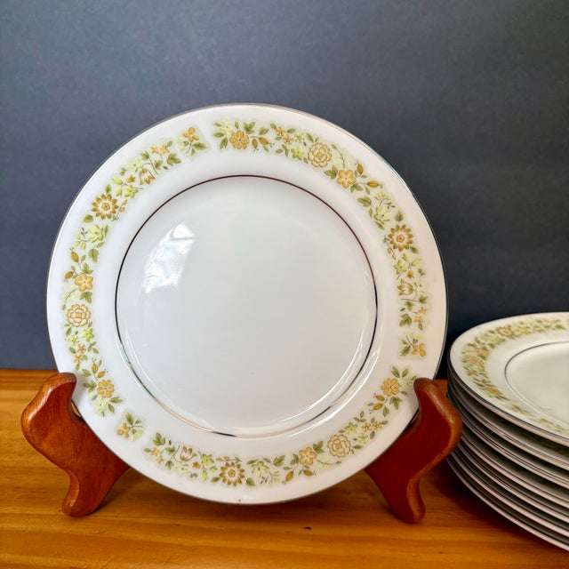 Vintae Bread & Butter Plates in the classic Towne House “Spring 3094” pattern. Featuring a delicate band of yellow florals...