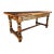 Substantial antique European farmhouse table crafted from solid oak, featuring a thick plank top, turned legs, and a...