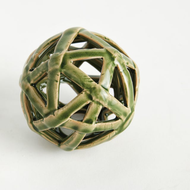 This contemporary little orb is made of thin ceramic strips giving it an open and airy feel. The dynamic, reactive glaze...