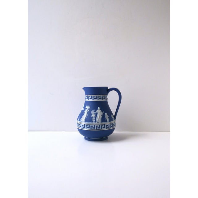 A beautiful cobalt blue and white Jasperware pitcher, with Greek-Key boarders, in the Neoclassical design style, by...