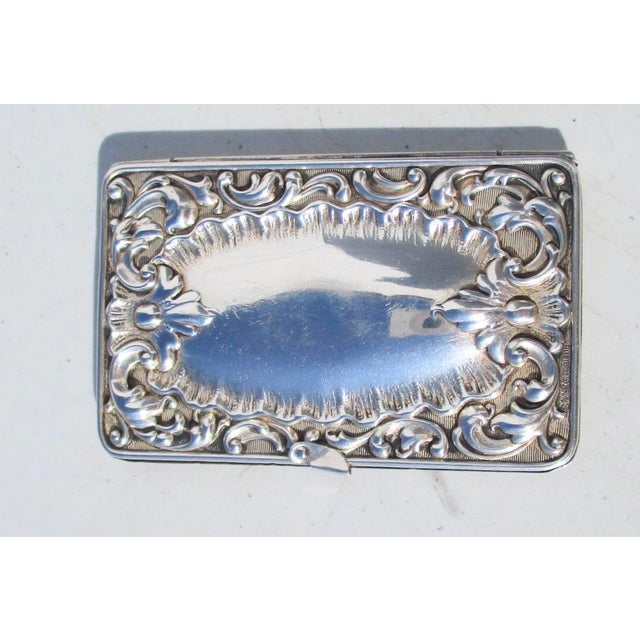 Sterling silver Victorian stamp box. Highly decorated rectangular box with scrolling monogram to The top side and stamped...