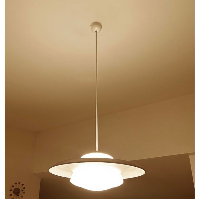 Exceptionnal set of 2 very large bauhaus pendant lights featuring an opaline glass shade on which a large sombrero style...