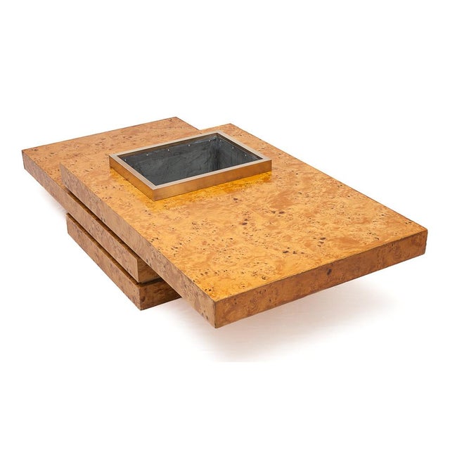 Coffee table by Jean-Claude Mahey. Elm burl and brass. Two tiers of shelves (30 cm and 20 cm). Brass rim. Integrated deep...