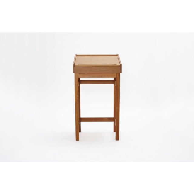 Made from oak with a slanted writing surface and brass hinges, the top opens up to reveal different storage compartments...