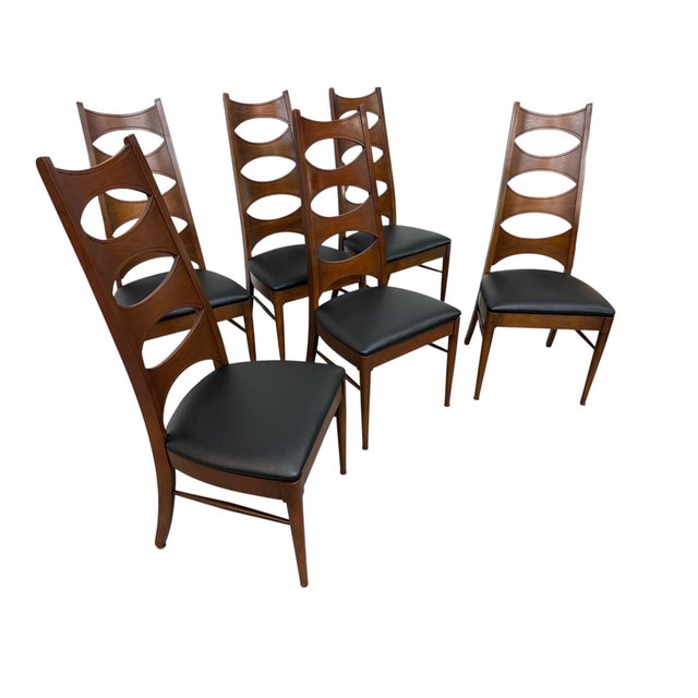 Elevate your dining space with this exceptional set of six Mid-Century Modern Kent Coffey Perspecta “Catseye” walnut...