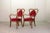 Elegant French pair of heart shaped side chairs. The wooden structured frame is upholstered with a red velvet seating and...