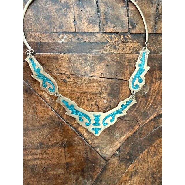 A striking vintage necklace crafted in alpaca silver and set with turquoise-toned inlay, formed in a series of articulated...