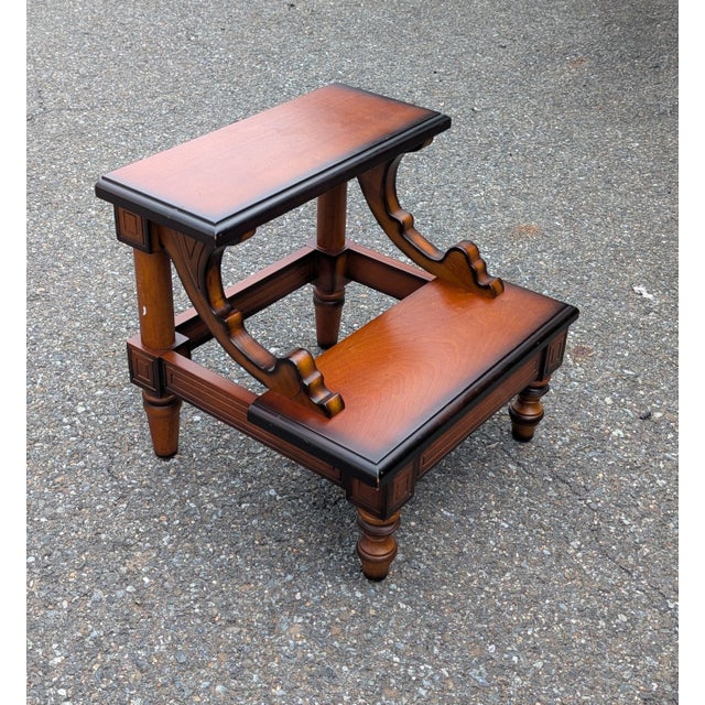 This vintage wooden step stool brings a touch of classic library elegance and practical utility to any room in your home....