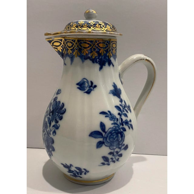 Continental blue and white lidded porcelain milk pitcher with gold details. Floral decorated, unmarked.