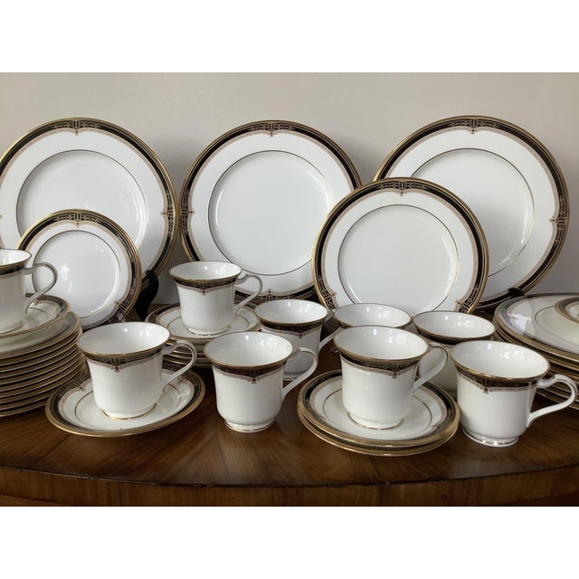 A large 55 piece set of Noritake fine china dinnerware in the Gold And Sable pattern with gold rimmed and black sable...