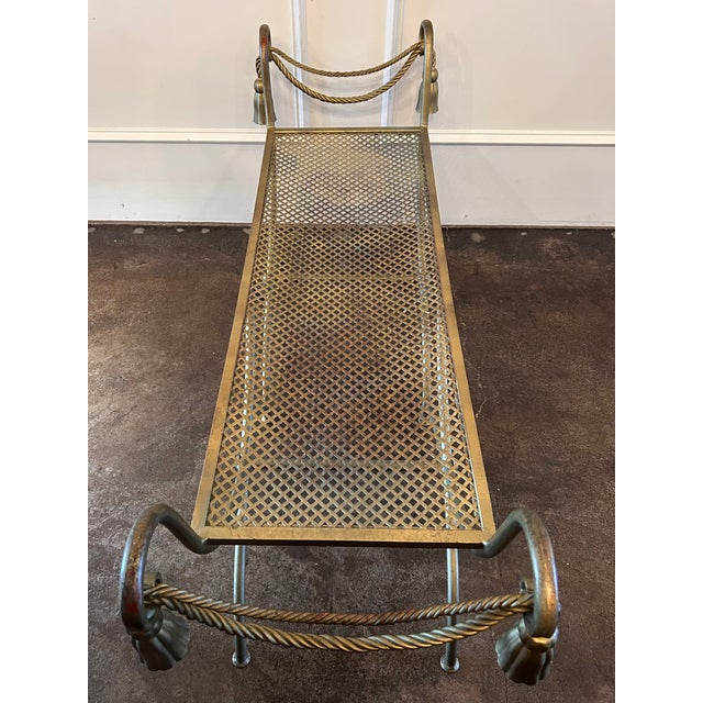 Mid 20th century Italian gilt metal rope and tassel bench, with rich patina of the red undercoat beneath the gilt finish....