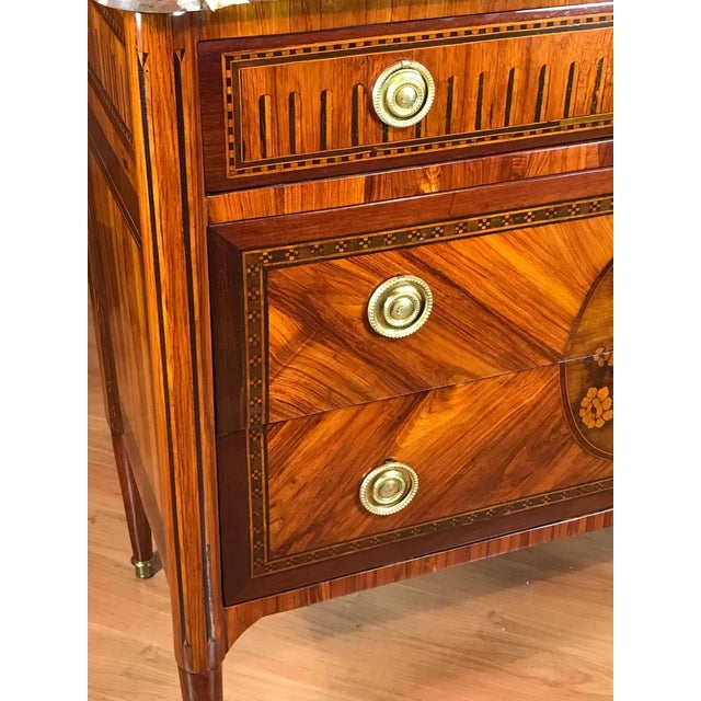 This refined marquetry Louis XVI chest of drawers originates in France and dates to around 1770, during the Transition...