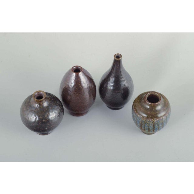 Wallåkra Ceramics, Sweden. Four small ceramic vases. Organically shaped vases in wheel-thrown stoneware with textured...