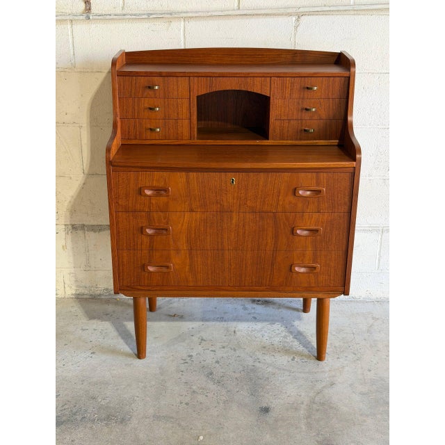 An elegant multi-functional form combines an adjustable pull-out writing surface with a hidden vanity mirror layout. The...