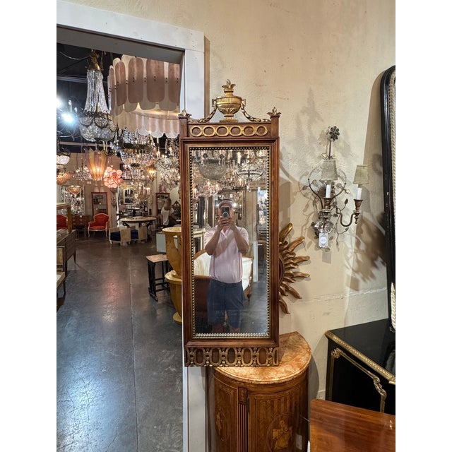 This product is a stunning 19th century Swedish walnut and gilt mirror, perfect for adding a touch of elegance to any room...