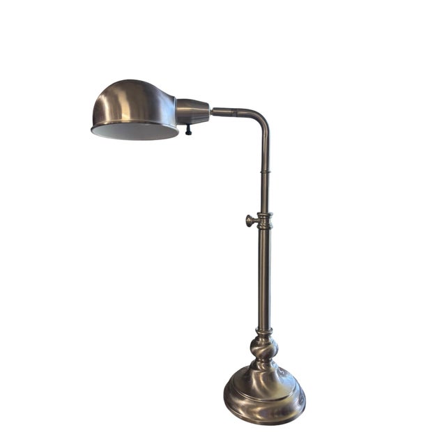 Clean-lined contemporary pharmacy style desk lamp featuring a brushed nickel finish, adjustable shade, and elegant...