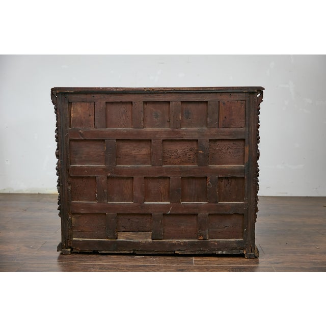A Spanish Renaissance walnut spice cabinet from circa 1680 with abundant foliage carved décor. This captivating Spanish...