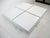 A very well crafted sophisticated 1970's white wood topped modular cube styled coffee table with X clear Lucite base with...