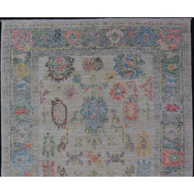 Measures: 4'2 x 6'2 Modern All-Over Floral Oushak with Muted Background and Accent Colors. Keivan Woven Arts: rug AWR-6825...