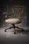 A sculptural pair of vintage swivel armchairs featuring intricate wrought iron scrollwork backs, gracefully curved arms,...