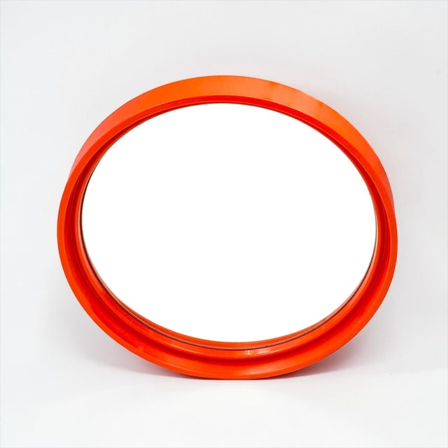 Vintage wall mirror produced by Gilac in France during the 1970s. This model features a bold circular frame in rigid...