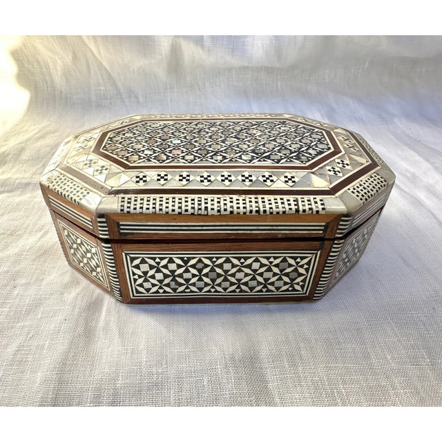 Handmade Egyptian Mother of pearl box cut into different shapes and then individually applied to form the finished...