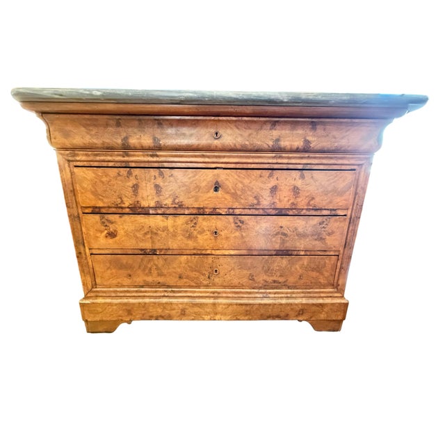 French Louis Philippe style antique dresser featuring a grey-veined marble top, wood veneer with rich grain patterning,...