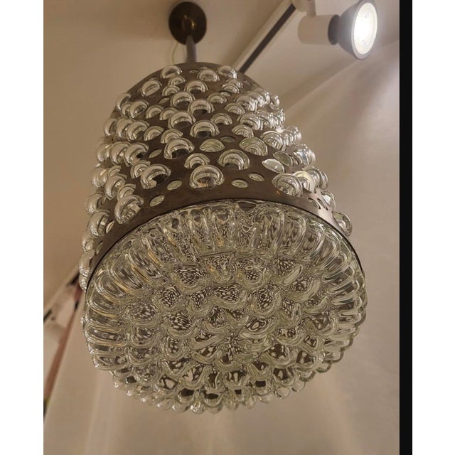 This bubble hanging lamp reflects the popular Mid-Century Modern aesthetic, known for its innovative designs and use of...