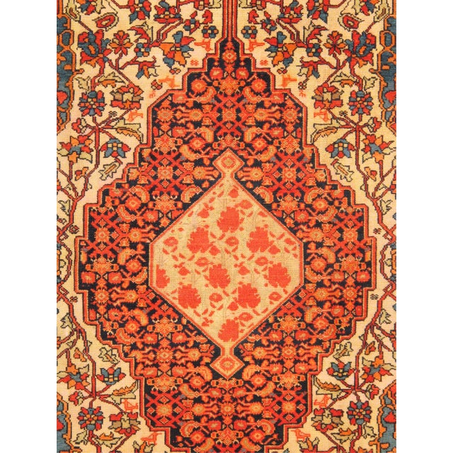 An antique Persian Malayer rug from western Iran, featuring a finely detailed Farahan-inspired floral medallion design....