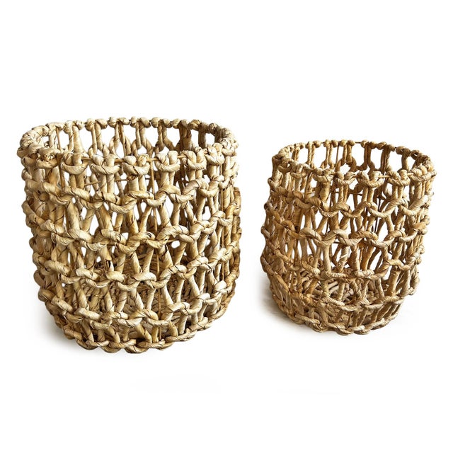 Hand woven natural water hyacinth leaf over wire frame. Great used as a basket for towels or blankets. Each is sold...