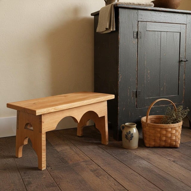 Handmade from natural pine wood, this rustic footstool features a rectangular plank top, decorative double-arched apron,...