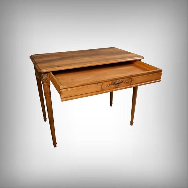 A walnut desk, crafted in the first half of the 20th century and bearing the stamp of master cabinetmaker Henry Geneste...