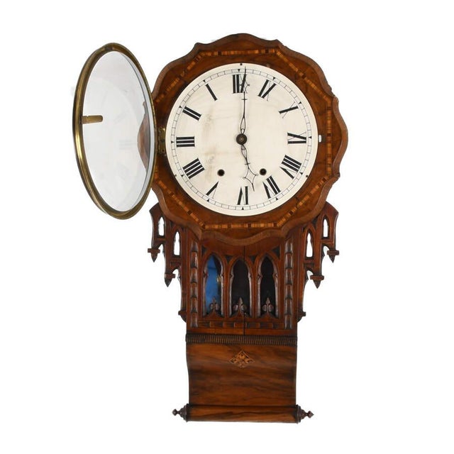 The Antique Walnut and Marquetry Inlaid Drop Dial Wall Clock is a beautiful 19th-century timepiece that combines function...