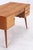 Vintage desk with clean lines and a well-organized front. Three drawers are located on the right, and there is a central...