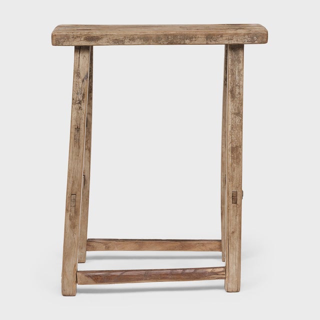 Crafted at the turn of the century, this rustic wooden stool would have been used throughout a courtyard home as versatile...