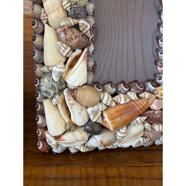 A charming pair of vintage shell-encrusted picture frames embodying the relaxed spirit of Old Florida coastal living....