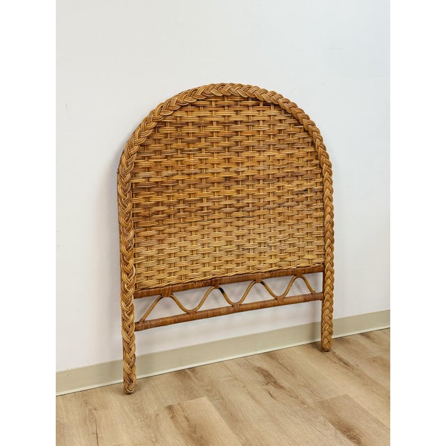 This vintage wicker headboard brings an easy, boho coastal sensibility to a twin bedroom, showcasing a hand-woven natural...