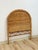 This vintage wicker headboard brings an easy, boho coastal sensibility to a twin bedroom, showcasing a hand-woven natural...