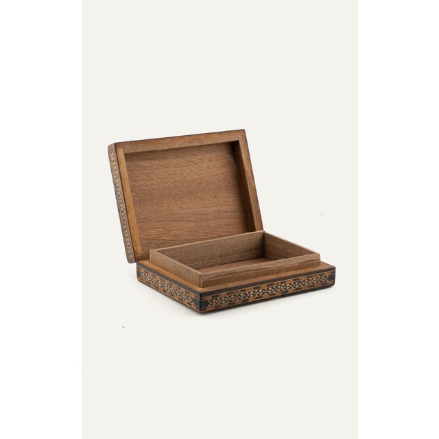 Vintage Syrian inlaid mosaic wooden box with geometric mother-of-pearl marquetry and a star-pattern lid. Boxes of this...